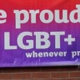 Banner on wall saying "We proudly support the LGBT+ community", with a tagline of "wherever profitable and convenient"