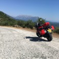 Motorcycle parked on scenic view across Greek mountains