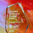 The Women in Drupal award, written out for Rachel Lawson, against the background imagery used in the Driesnote